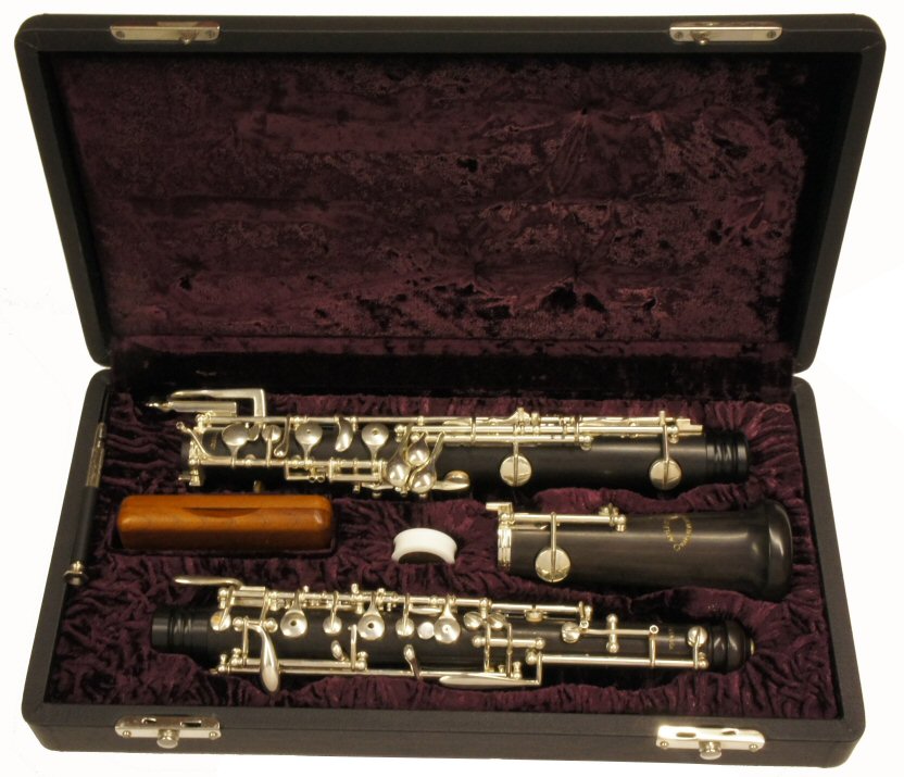 Adler Semi-Automatic Oboe. Semi-automatic, dual system, forked F vent key, auxiliary F, 3rd octave & 2 trill keys. Outfit includes a case cover & wooden reed case