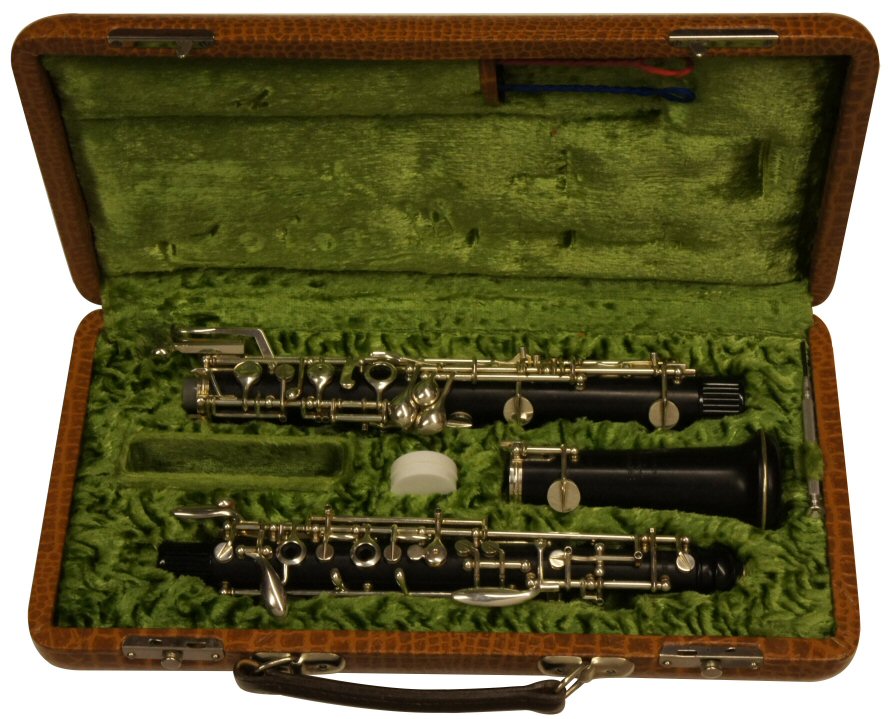 Mönnig Fully Automatic Oboe. New but old stock. Fully automatic, dual system, forked F vent key, auxiliary F & C (banana) keys. Outfit includes canvas case cover & cleaning mops. Price £1699.00